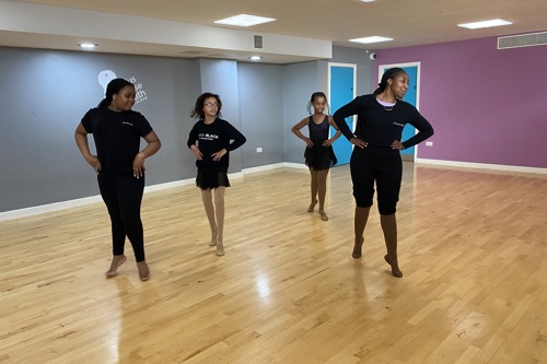 Young Black ballerinas train with a dance teacher at Pointe Black ballet school