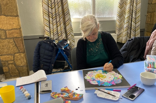 A member of Tooting Community Kitchen enjoys arts and crafts