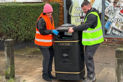 Judi and a council officer moving a new bin to its new home in Tooting