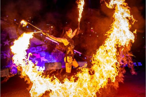 A woman creating a ring out of fire