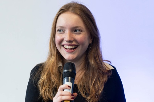 Youth Mayor Millie Quinn speaks into a microphone at an event