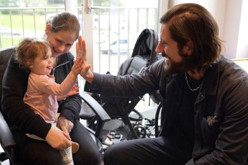 Councillor Aydin Dikerdem gets a high-five from April's daughter