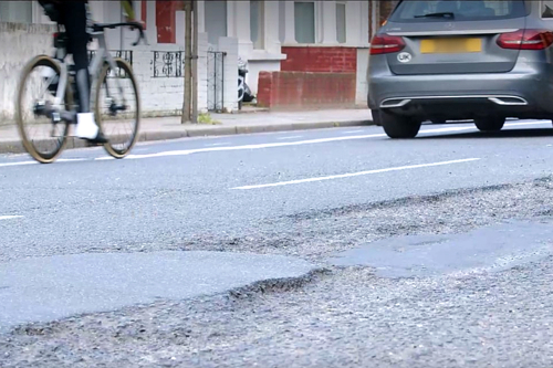 Uneven road surface with bike and car